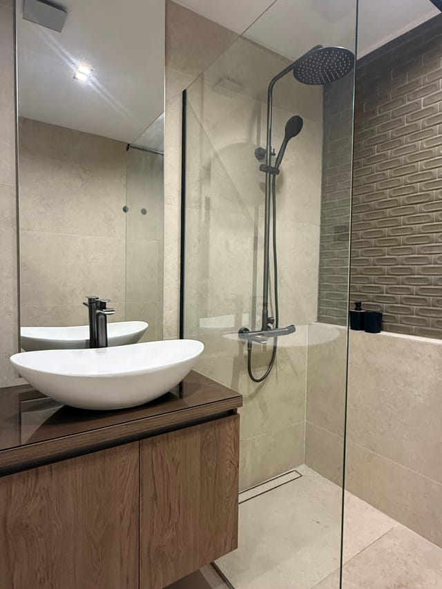 Bathroom vanity and glass walk-in rain shower