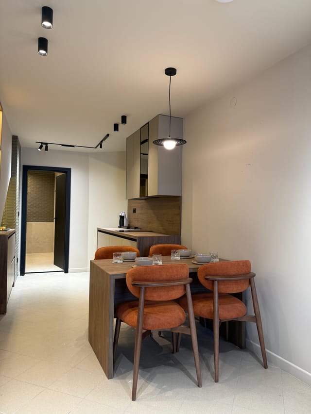 Dining table set for four beside the kitchen